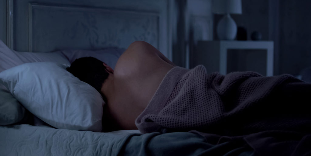 Man getting a good nights sleep for optimal muscle recovery